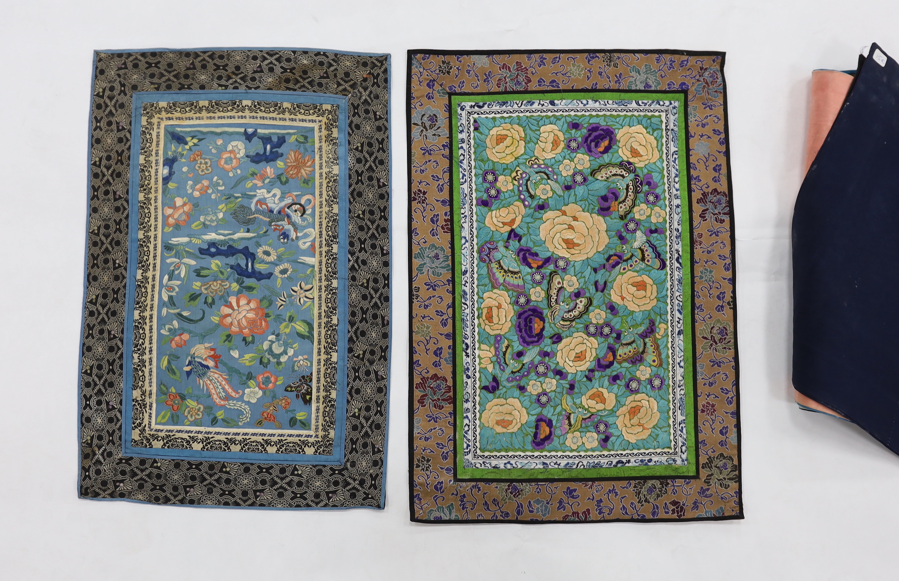 Nine large Chinese polychrome embroidered mats, embroidered with birds, bats, flowers and butterflies, all bordered with silk brocade